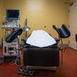 A procedural table set up in a medical room.