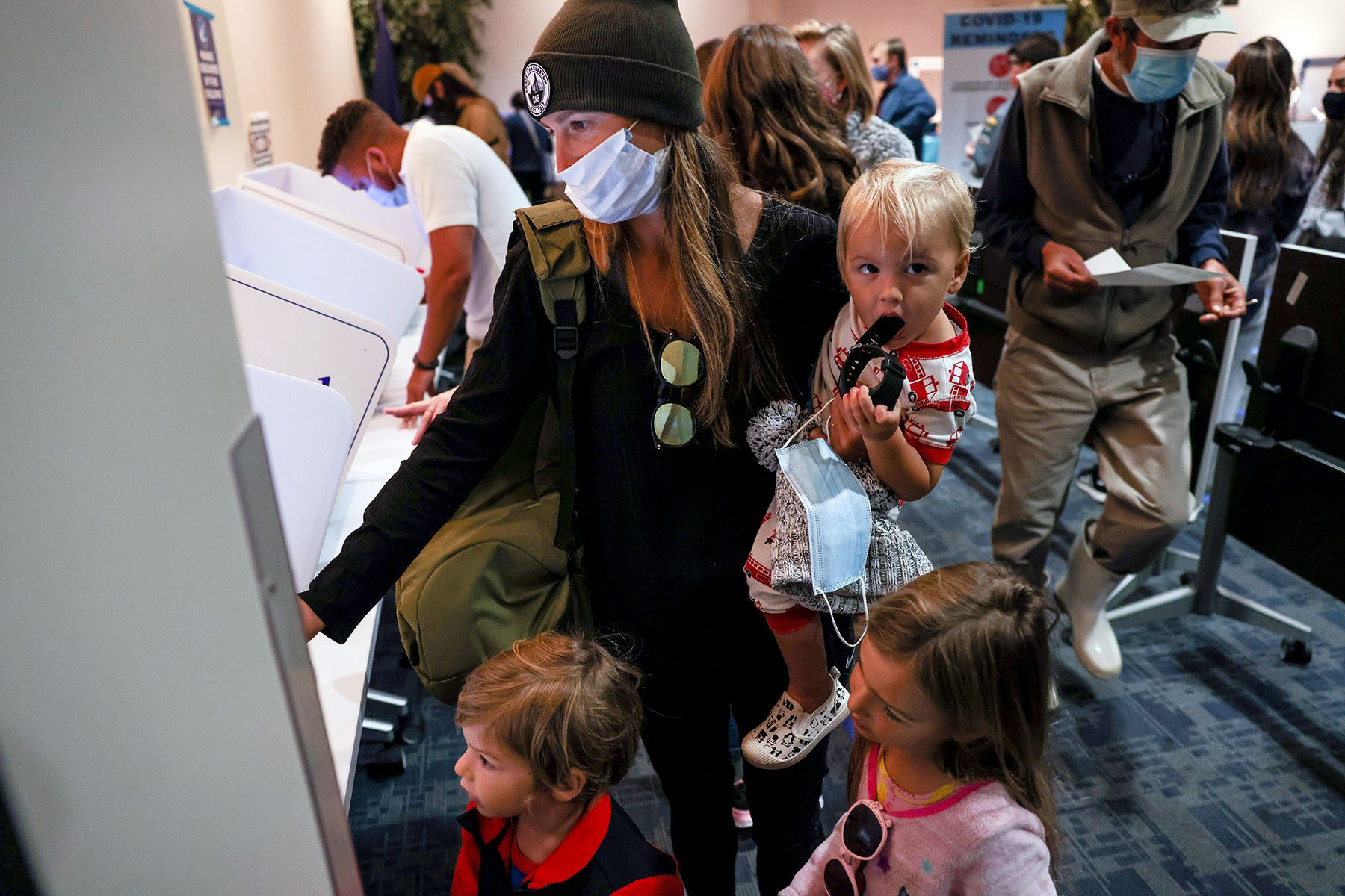 With her three kids in tow, Staci Dearing casts her in-person absentee ballot at the Charleston County Public Library.