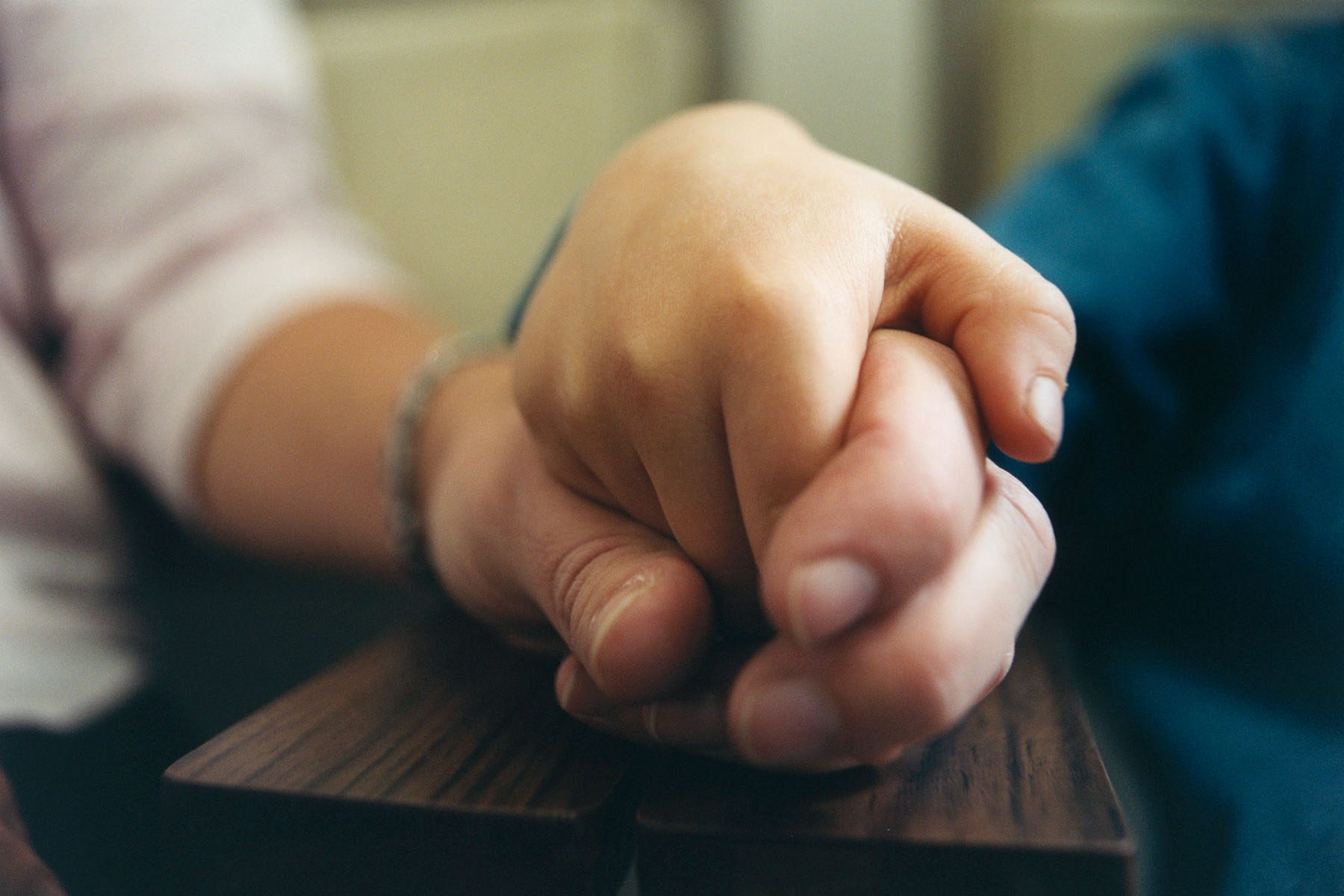 Person holding son's hand