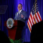 Education Secretary Miguel Cardona delivers remarks at a podium.