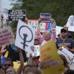 A woman holds a sign at a protest in Indianapolis.