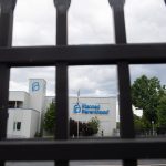 A fence in the foreground with a Planned Parenthood building in the background.