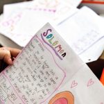 A teacher holds a letter from a former student that reads 