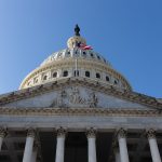 The American flag flies at the top of the U.S. Capitol building.