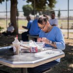 Jolina Olivia Diaz, a transgender female inmate, makes jewelry in the yard of a men's prison in California.