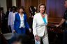 Nancy Pelosi smiles as she walks into a room on Capitol Hill