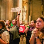 Abortion rights activists react after the Indiana Senate votes to enact a near total abortion ban.