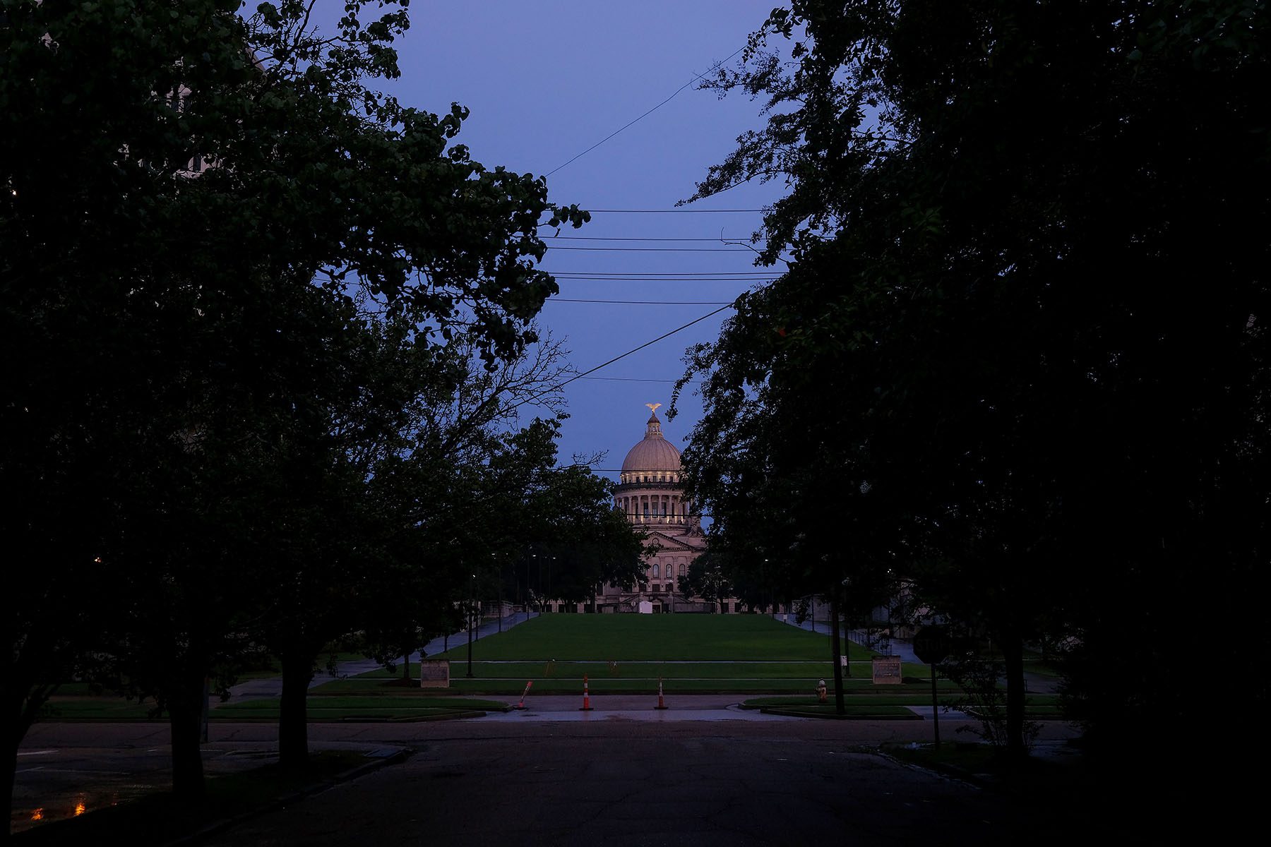 Trees are seen in the foreground of the Mississippi Capitol building