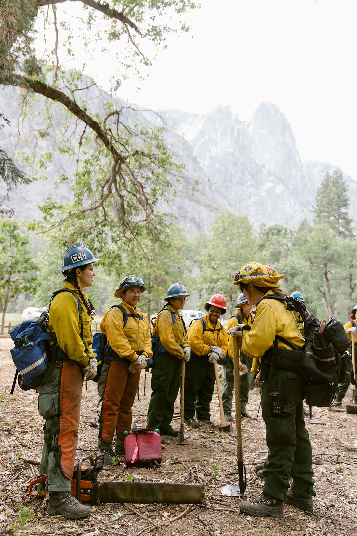 Members of the all-women wildland fire crew are briefed by their leader for the day’s tasks.
