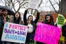 Harvard University freshmen carry signs that read 