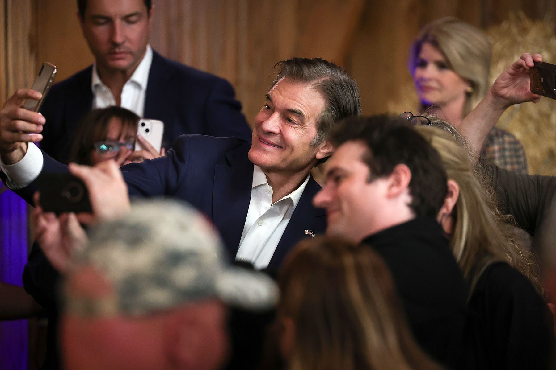 Dr. Mehmet Oz greets audience members after speaking at a campaign event.