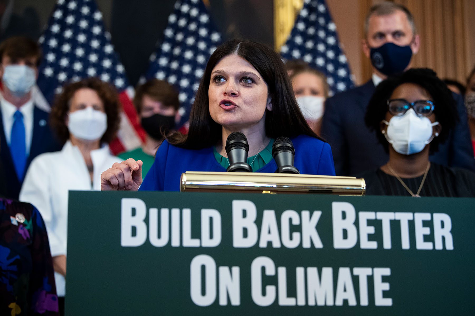 Haley Stevens speaks at a podium as she conducts a rally to promote climate benefits in the Build Back Better Act in the U.S. Capitol.