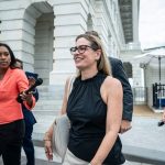 Sen. Kyrsten Sinema departs after a vote on Capitol Hill.