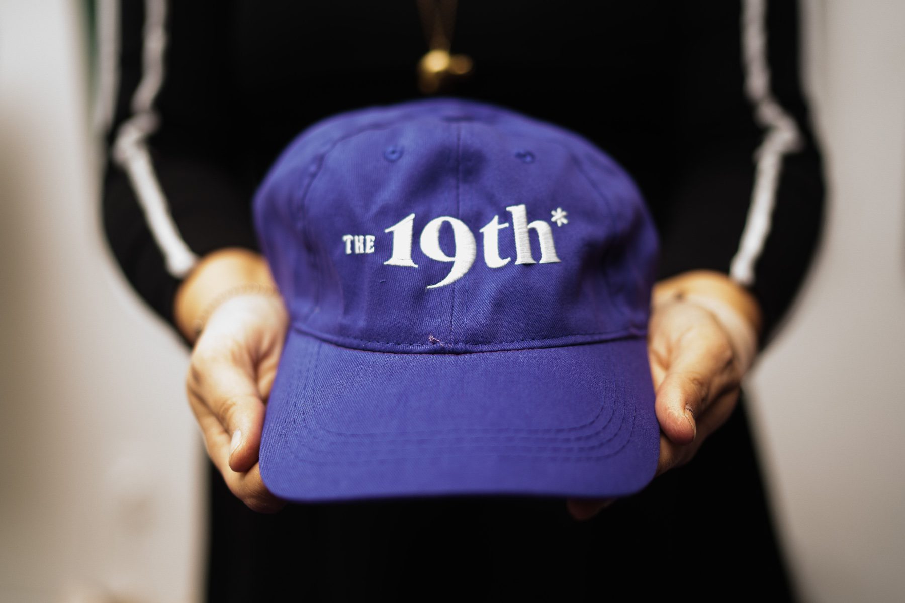 Purple baseball cap with "The 19th" stitched on it.