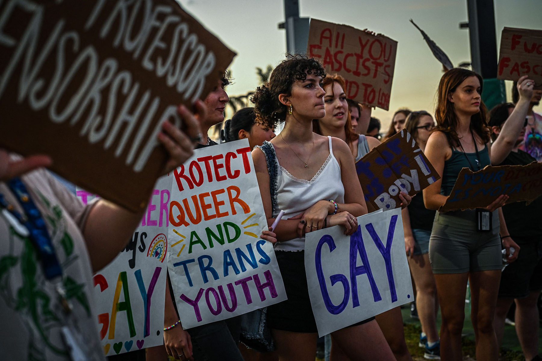 LGBTQ+ rights supporters protest against Florida Governor Ron DeSantis outside a "Don't Tread on Florida" campaign event.