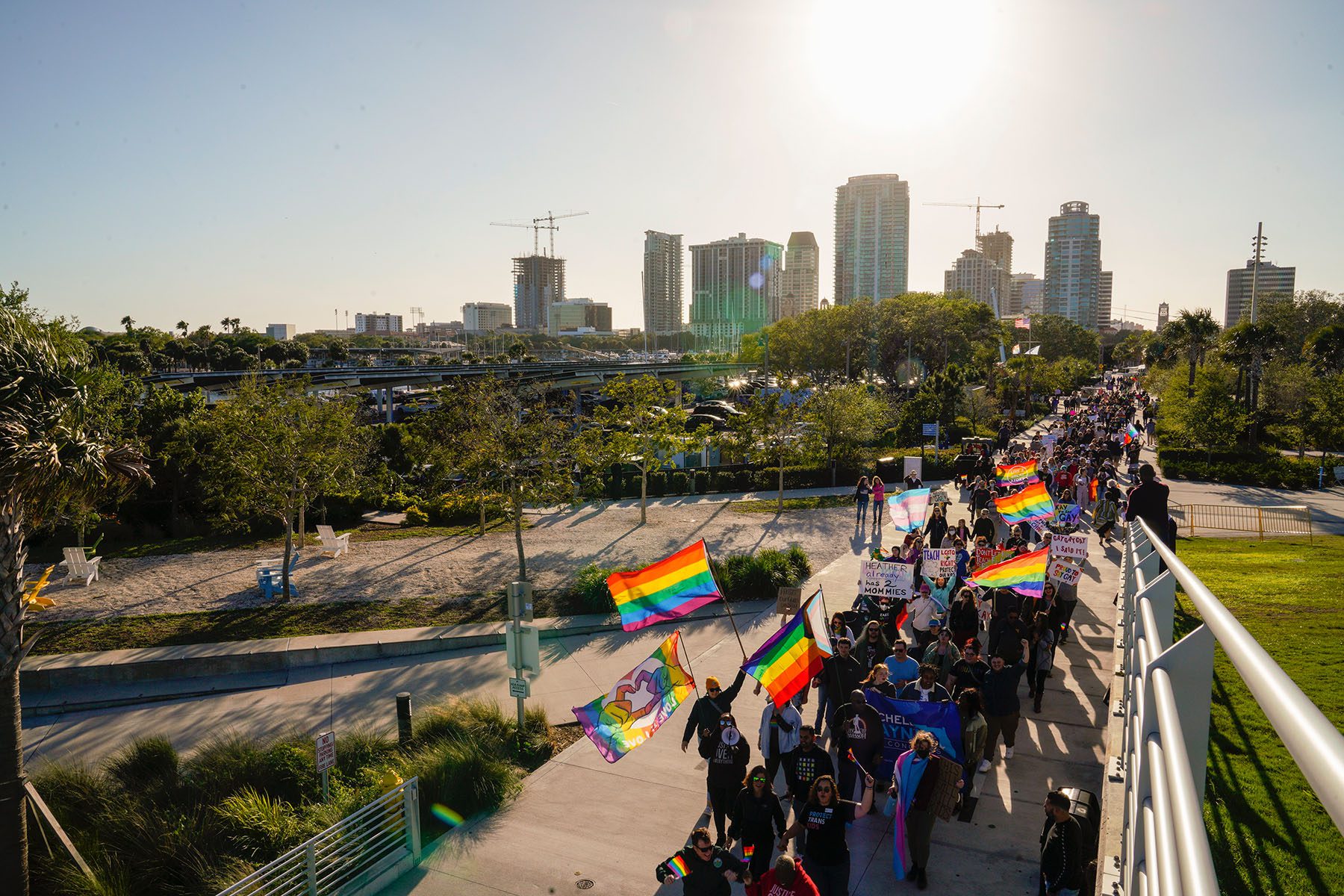 Demonstrators wave pride flags as they march across a bridge in protest of Florida's "Don't Say Gay" bill in St. Petersburg, Florida.