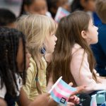 Young students listen to a reading of 