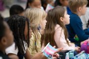 Young students listen to a reading of 