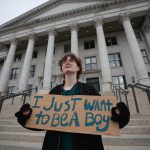 A protester holds a sign that reads 