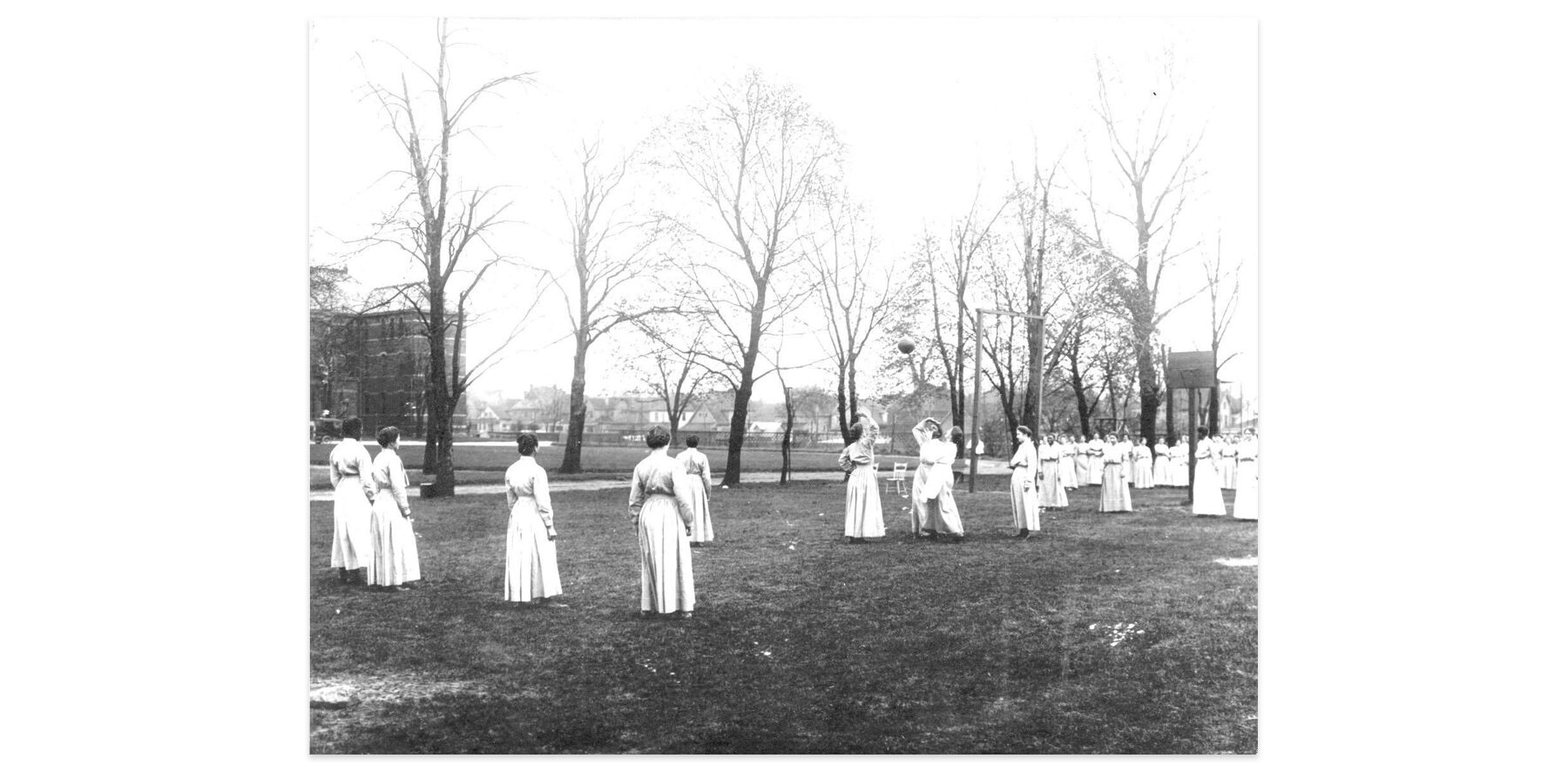 An archival photo of women prison playing a game in the prison yard.