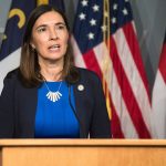 Supreme Court Justice Anita Earls at a podium speaking at a conference speaking about the goals of the North Carolina Task Force for Racial Equity