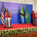 Vice President Kamala Harris speaks at a podium with Tanzania's President Samia Suluhu Hassan.