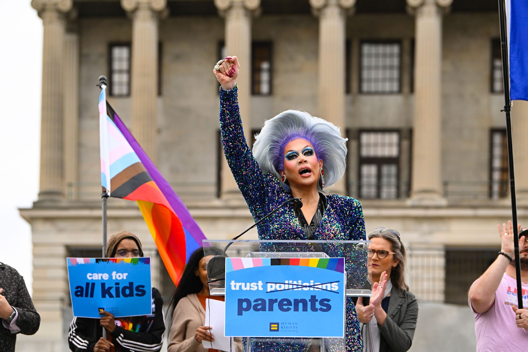 Drag artist Vidalia Anne Gentry raises her fist as she speaks during a news conference in front of the Tennessee Capitol.