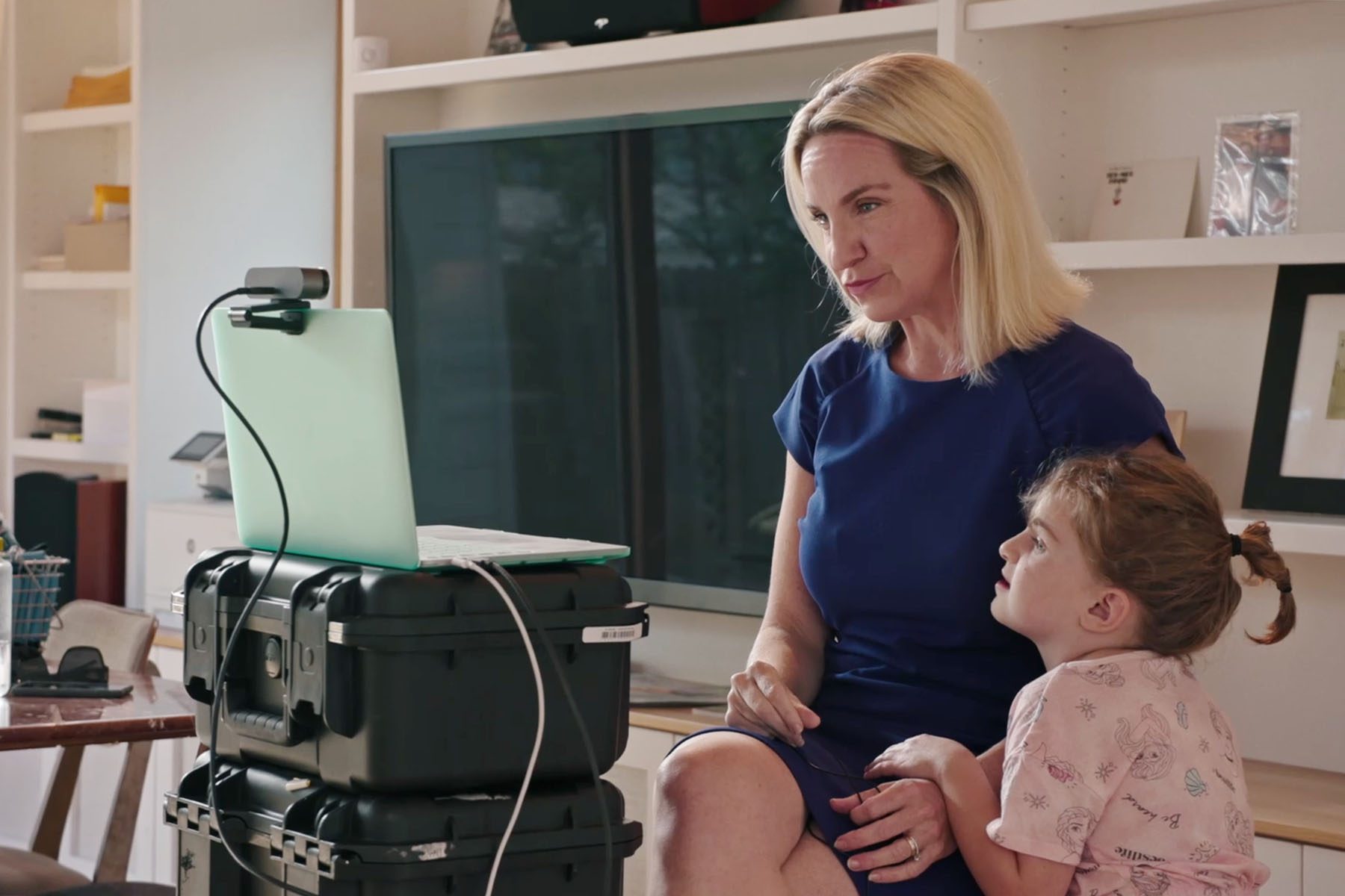A still from Breaking The News shows 19th co-founder and CEO Emily Ramshaw getting ready for an interview with her young daughter by her side.