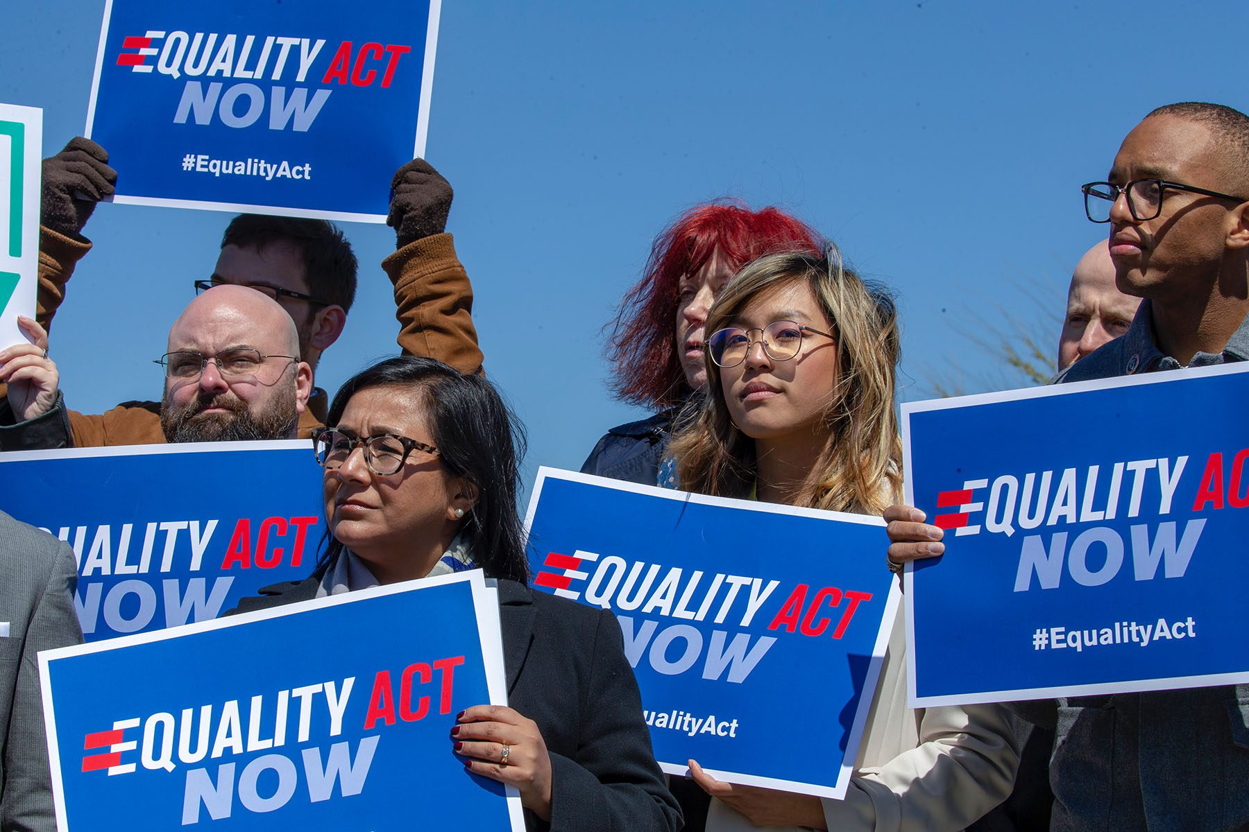People holding signs that read "Equality Act Now" stand in support of the Equality Act on Capitol Hill.