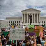 People protest in response to the Dobbs v Jackson Women's Health Organization ruling in front of the Supreme Court.