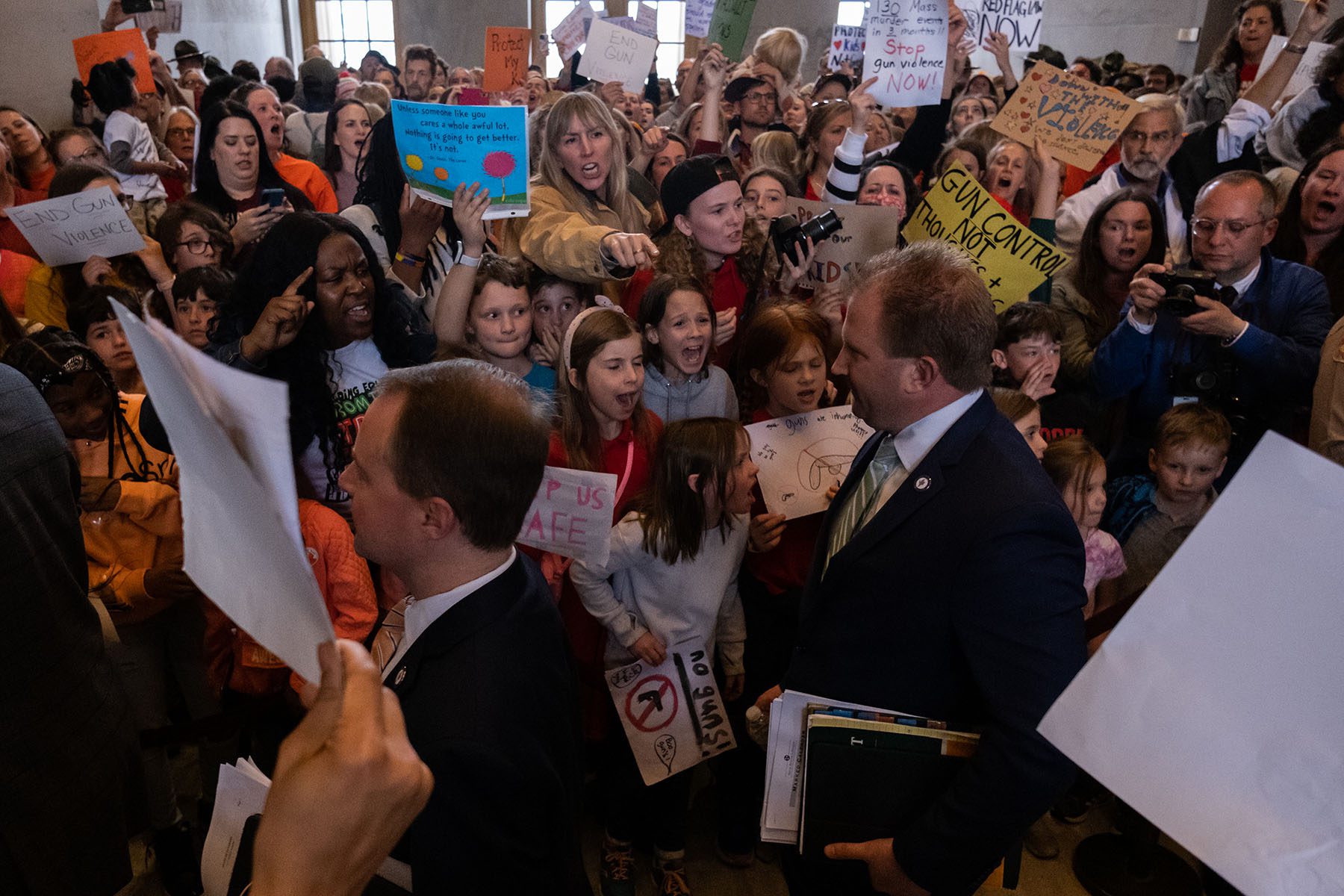 Republican state Rep. William Lamberth enters the house chamber as protesters chant demanding action for gun reform laws at the Tennessee State Capitol.