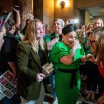 State Sens. Megan Hunt, Jen Day and Sen. Machaela Cavanaugh embrace while being cheered on by supporters after a bill seeking to ban abortions in Nebraska after about six weeks failed to advance.