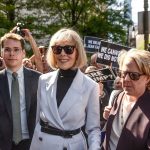 E. Jean Carroll leaves following her trial at Manhattan Federal Court as supporters hold signs and cheer around the courthouse.