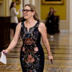 Sen. Kyrsten Sinema walks through the Capitol