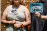 People hold up signs as they have their picture taken at a photo booth during a 