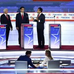 Nikki Haley looks on as Chris Christie, Mike Pence, Ron DeSantis and Vivek Ramaswamy speak on stage during a break in the first Republican Presidential primary debate.