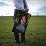 Mark Barden holds a picture of his son on the national mall during a call for action on preventing gun violence.