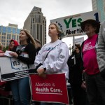 People attend a rally hosted by Ohioans United for Reproductive Rights outside of the Ohio Statehouse.