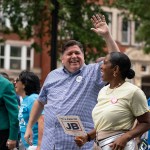 Illinois Governor J.B. Pritzker and Lieutenant Governor Juliana Stratton walk in the 93rd annual Bud Billiken Parade.