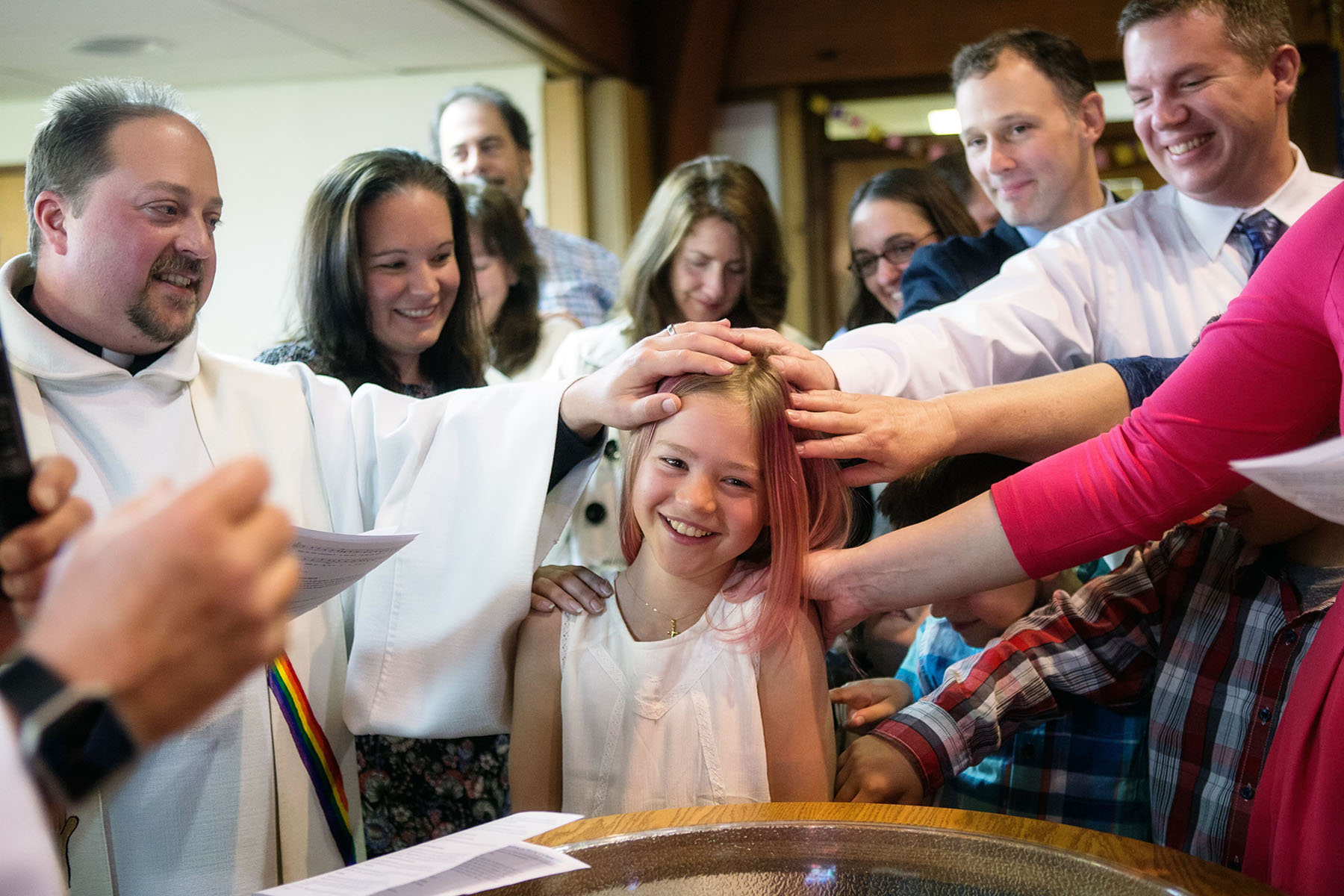 Rebekah smiles as her congregation blesses her during a "Name Blessing," which was held on the 10th anniversary of her baptism and two years after her transition, with her grandfather, who had baptized her, presiding.