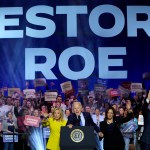 President Joe Biden is joined on stage by first lady Jill Biden, Vice President Kamala Harris and second gentleman Doug Emhoff at an event on the campus of George Mason University.