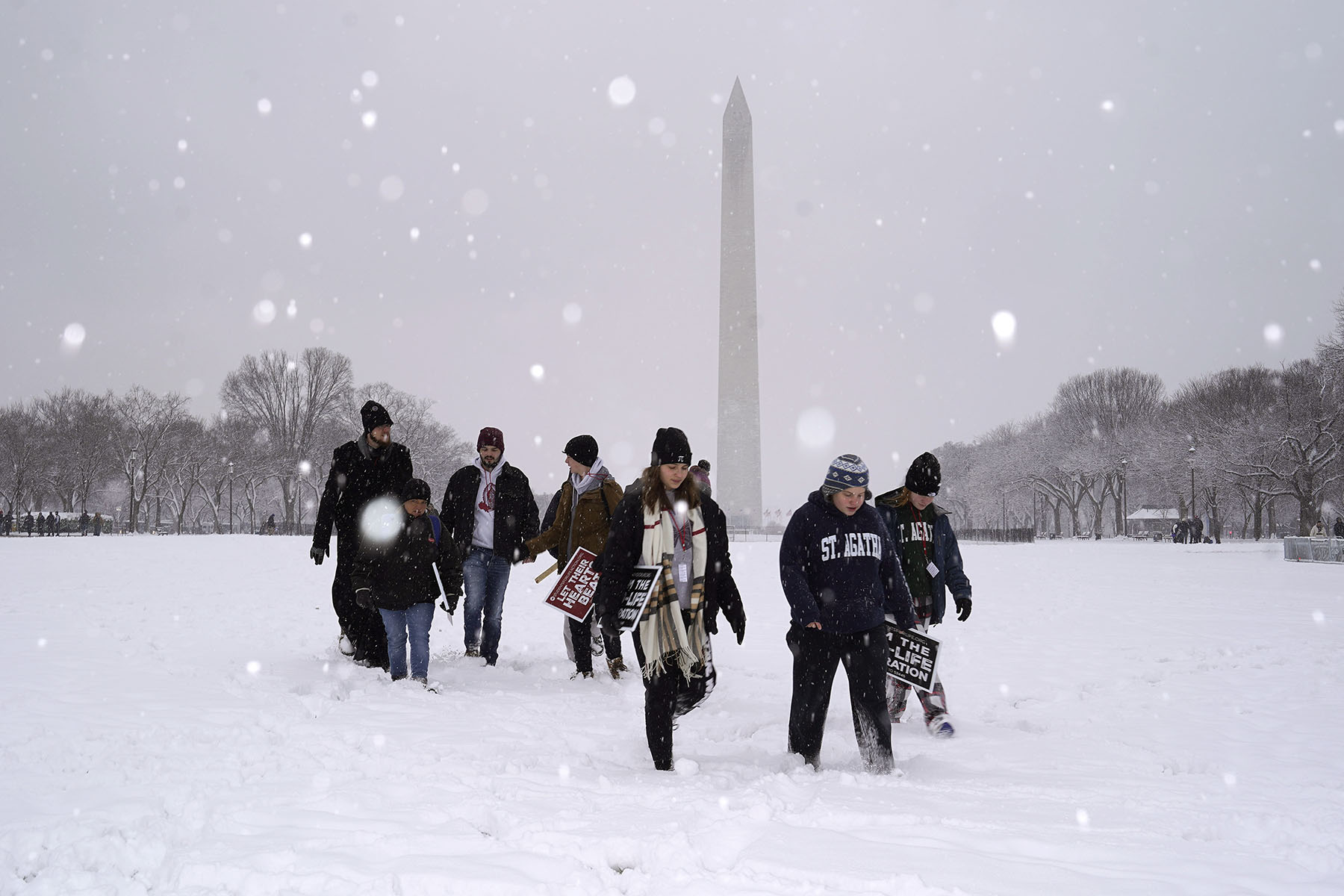 Amidst snow and freezing temperatures, a group of people walk on the Nartional Mall to attend the annual March for Life rally on January 19, 2024 in Washington, D.C.