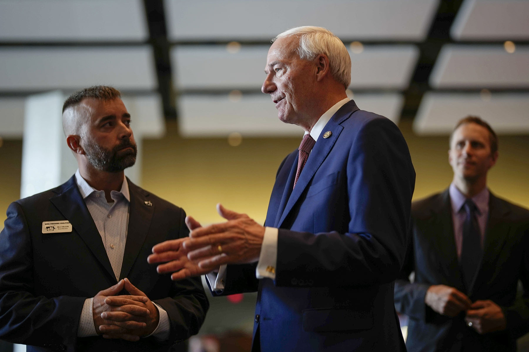 Asa Hutchinson speaks to a man at at the Iowa Faith & Freedom Coalition's fall banquet in 2023.