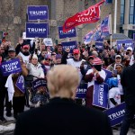 Former president Donald Trump greets supporters outside a polling location at a high school in Londonderry, New Hampshire.