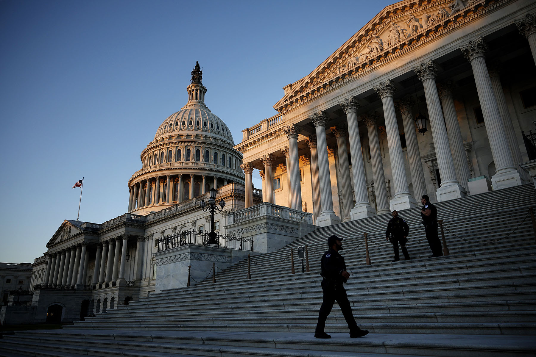 U.S. Capitol Police stand watch on the East Front at sunrise in Washington, D.C.