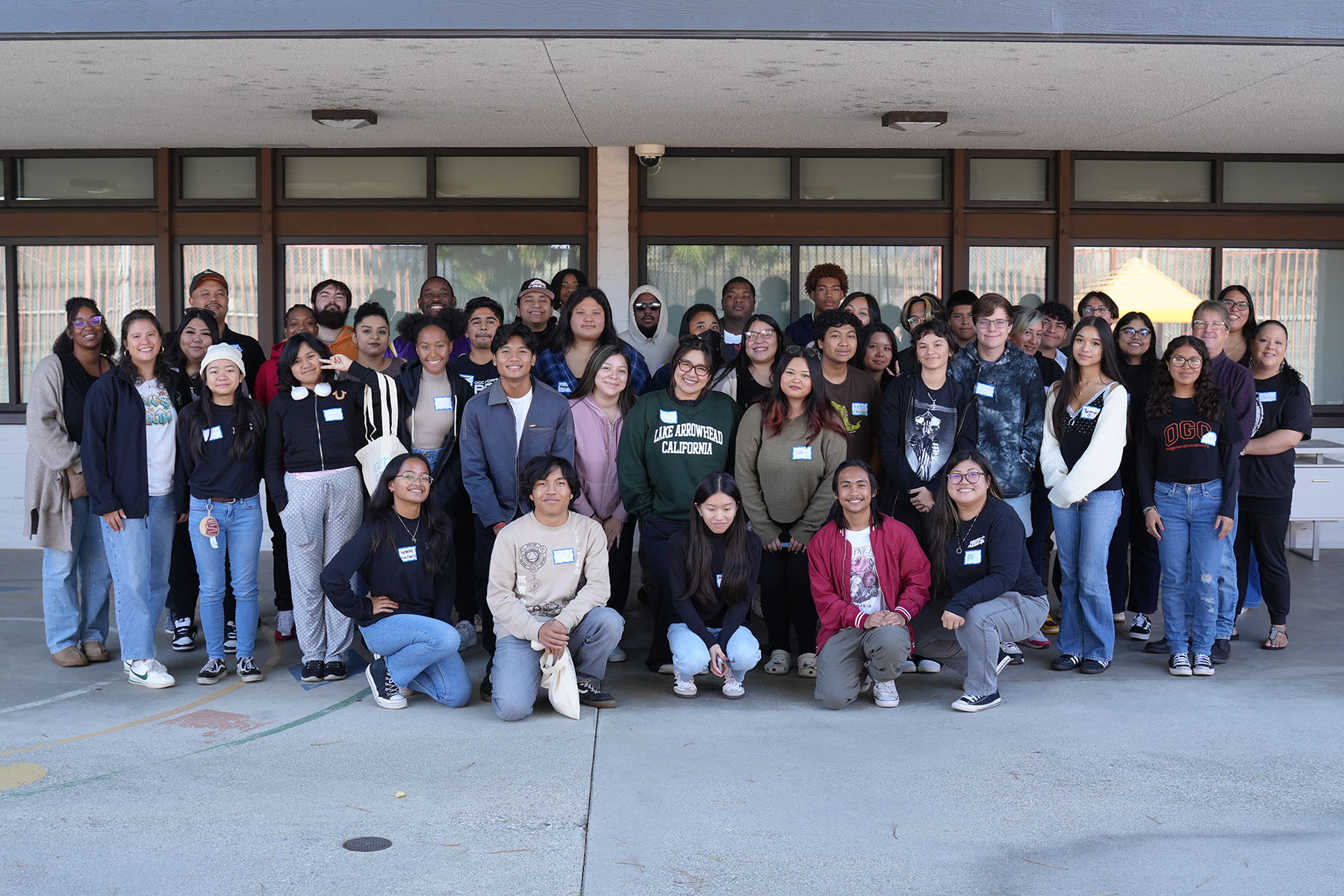 A group of youth pose after a workshop.