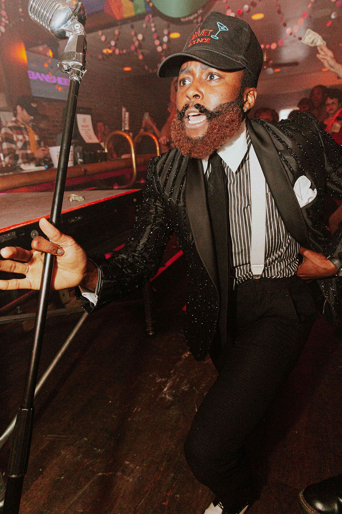 King Molasses performs in a bar as patrons watch.