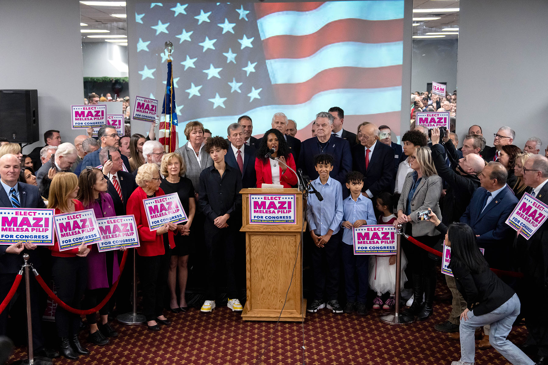 Mazi Melesa Pilip, surrounded by supporters, speaks during a press conference at American Legion Post 1066.