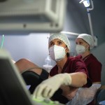 Doctors around a woman during a fertility treatment in a clinic.