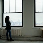 Thalia Gonzalez looks out a window onto New York City.